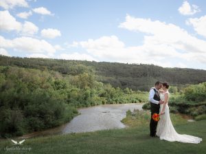 newlyweds by a river