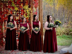 bridesmaids standing in a row looking toward something out of frame