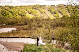 Newlyweds standing in a valley