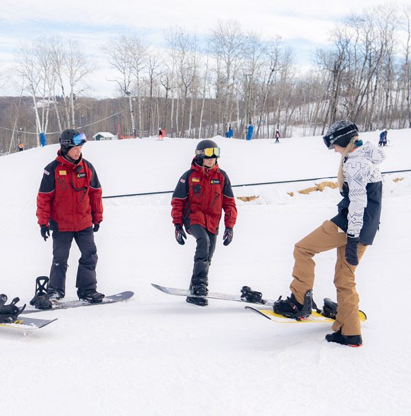 Snowboard Instructors and a Student
