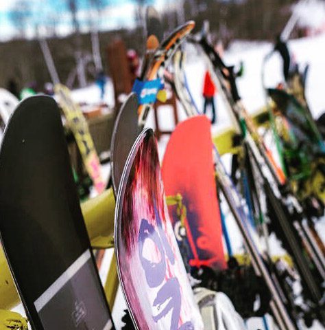 Skis and snowboards on a rack