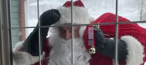 Santa looking through a window.