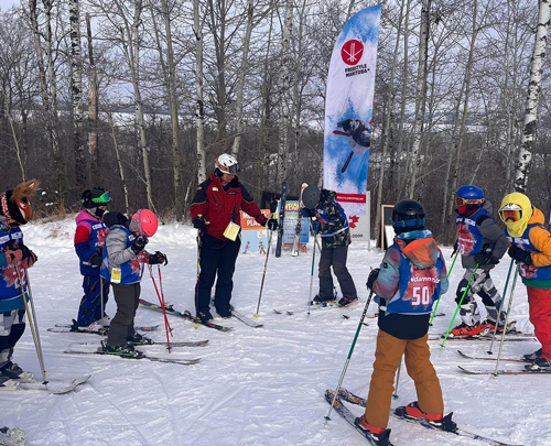 An instructor speaks to students leaning how to ski at Asessippi Ski Resort