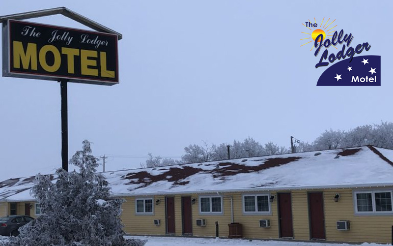 A yellow motel sitting in a snowy terrain. This motel is the Jolly Lodger Motel.