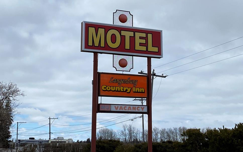 A large, red Motel sign advertising vacancy at the Langenburg Country Inn