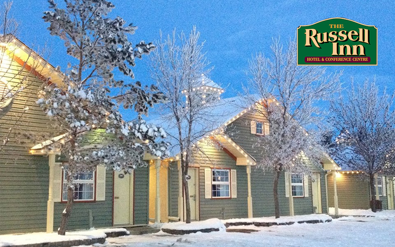 Green houses sit outside on the snow at the Russell Inn.