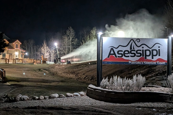 A lit up sign that reads "Asessippi Ski Resort".